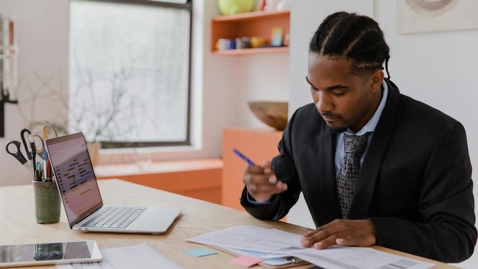 Business owner reviewing website design notes at a modern office desk