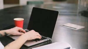 Web design Miranda workspace with laptop, notebook, and office desk setup