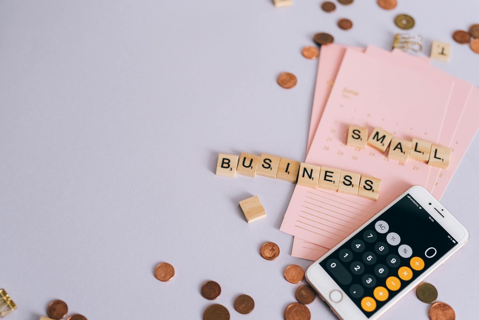 Website pricing notes and planning paperwork on a desk